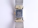a watch that is sitting on a white surface
