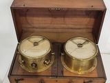 a wooden box that has two different types of clocks inside of it