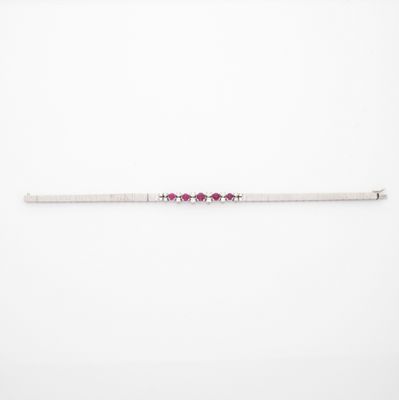 a silver bracelet with pink stones on a white background