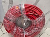 a red hose that is wrapped in plastic on the floor