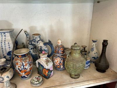 many different vases on a shelf in a room