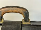 a close up of the handle of a black suitcase