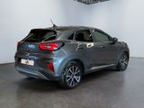the rear end of a grey car in a showroom