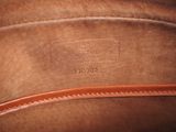 a close up of a brown bag with a leather handle