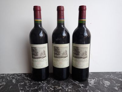 three bottles of wine sitting on top of a table next to each other
