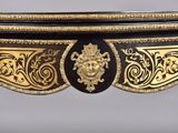 an image of a gold and black table with a lion head on the top