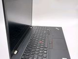 a laptop with a black keyboard sitting on a white surface
