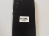 a close up of the back of a black phone with a sticker on it