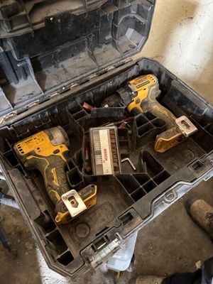 une boîte à outils contenant des outils, posée sur le sol