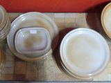a lot of plates and bowls on the table