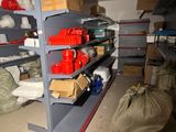 many shelves with various items on them in a room