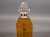 a close up of a bottle of perfume on a table