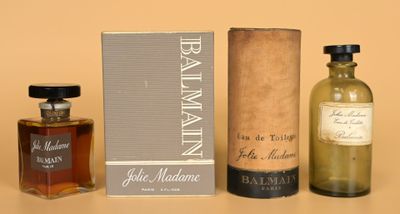 two bottles of perfume sitting next to each other on a table