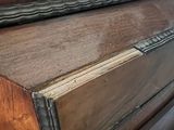 a close up of a piano with a wooden top