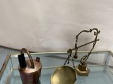 brass and glass tray with a tea kettle, teapot, and spoon on it