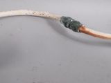 a small piece of wood with a wire attached to it