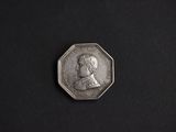 a close up of a silver coin with a portrait of a man on it