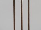 wrought iron plant stand with a basket of flowers on top