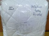 a pillow that is wrapped in plastic on a table