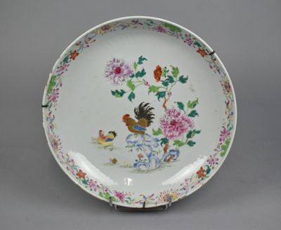 a white plate with a bird and flowers on it
