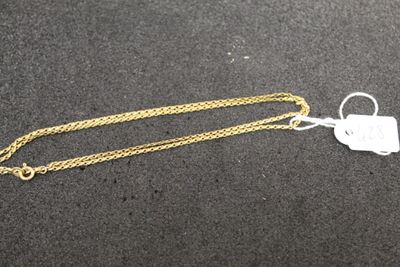 a close up of a gold chain with a tag on it