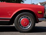 an image of a red car parked in a parking lot