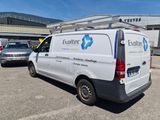an image of a van parked in a parking lot next to a building