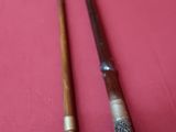 two old canes are sitting on a red cloth