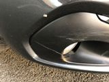 a close up of a car ' s exhaust pipe on the ground