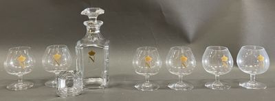 bottles and glasses are lined up in a row on a table