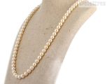 a close up of a mannequin with a pearl necklace on it