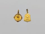 two gold pendants depicting the virgin and child