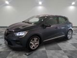 the grey car is parked on a checkered floor in a garage