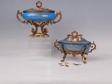 two blue and gold vases and a bowl on a stand