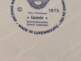 a close up of a white plate with a blue emblem on it