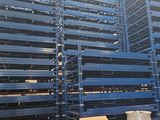 a large amount of pallets are stacked up in a warehouse