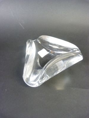 a clear glass object sitting on a black surface