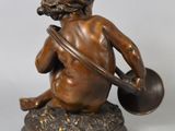 bronze figurine of a boy with a bowl and a jug