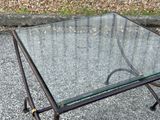 a glass table with a metal frame and a glass top