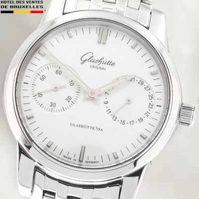 a close up of a watch on a white surface