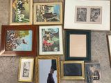 a lot of framed pictures on the floor of this room