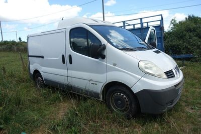 a white van that is parked in the grass