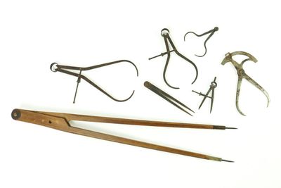 many different tools that are sitting on a white surface