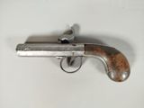 a close up of a gun on a table with a white background