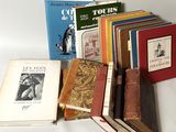 several books are stacked on top of each other on a table