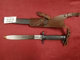 two old knives with leather sheaths on a red background