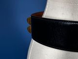 a close up of a mannequin torso with a black leather belt