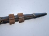 a knife with a leather strap on it sitting on a table