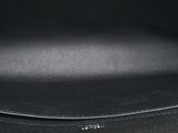 the inside of a black purse with a silver handle
