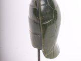 statue of a helmet on a wooden base on a white background